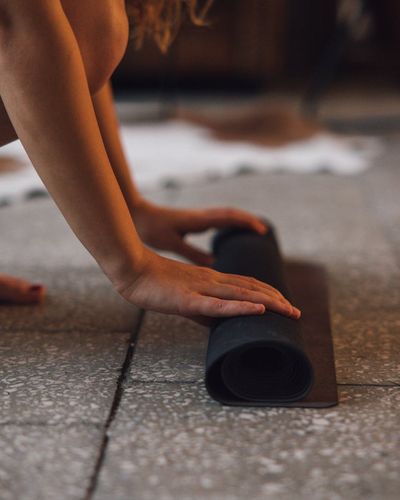 Close-up shot of yoga mat and water bottle, showing preparation for exercise.